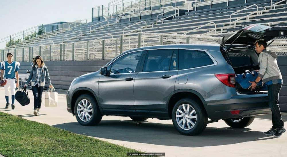 A blue 2021 Honda Pilot is shown being packed after football practice.