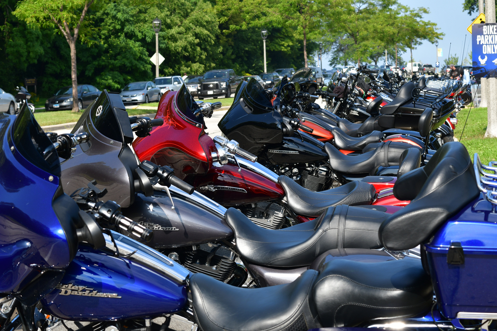 a blue Harley Davidson bike is the first bike in a long line of Harley Davidson motorcycles parked in a line in a parking lot located in Milwaukee, WI