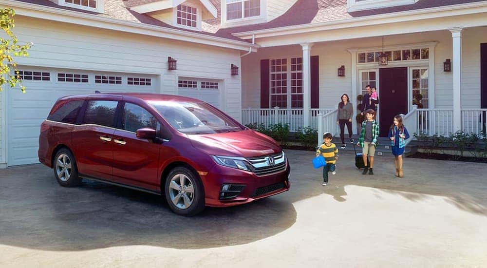 Red 2020 Honda Odyssey parked on a driveway.