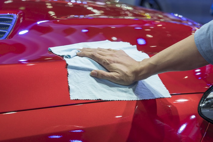 Polishing a shiny red car