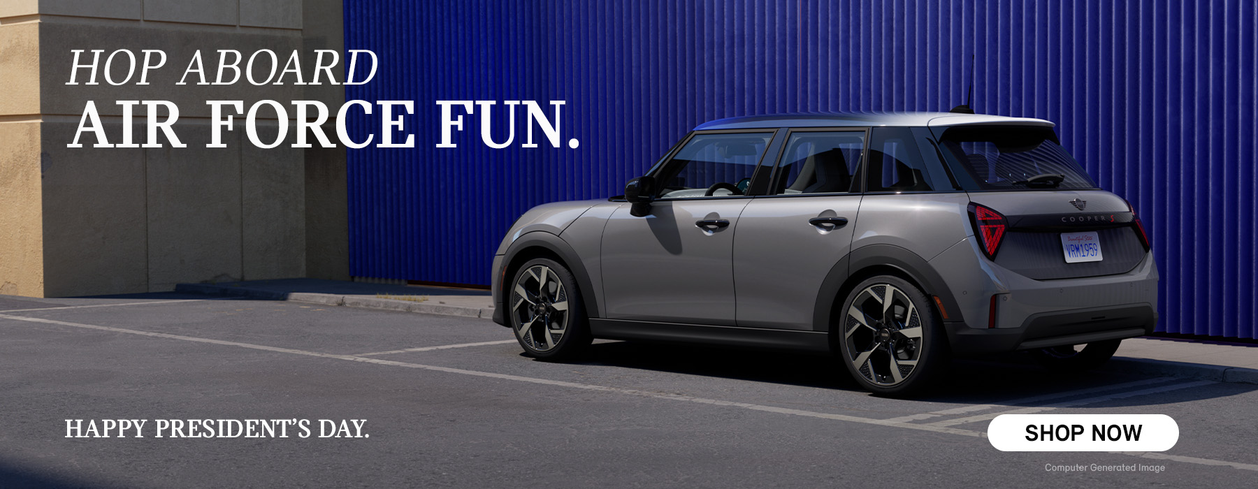 Gray MINI 4 Door parked in front of a blue wall.