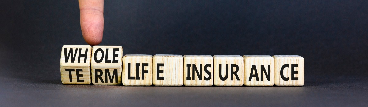 Whole or Term Life Insurance Spelled in Blocks with Finger Holding Them