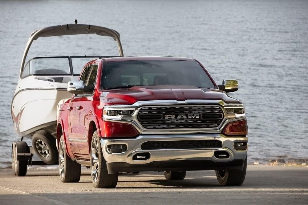 Red Ram 1500 towing a boat along the waterfront