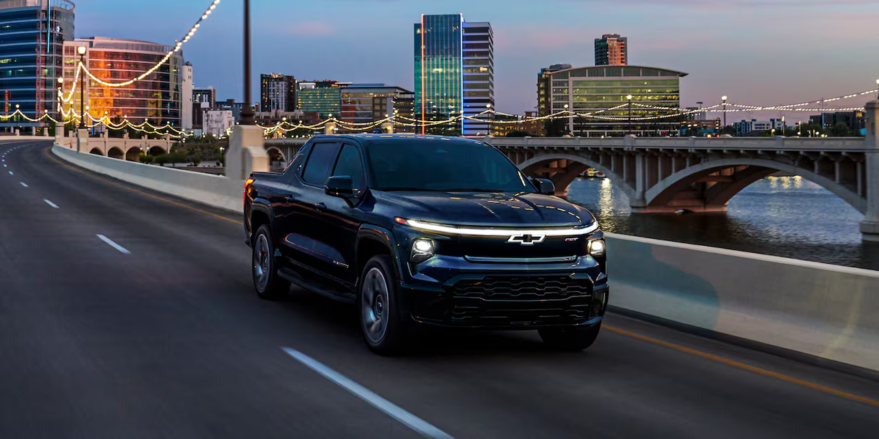 A 2024 Chevrolet Silverado EV drivin on a road.