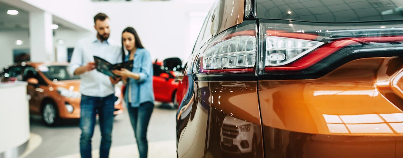 Two people in a dealership.