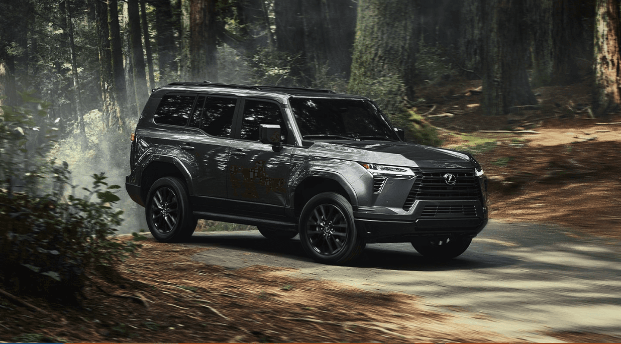 Side view of the 2024 Lexus GX in a forest or woodsy area