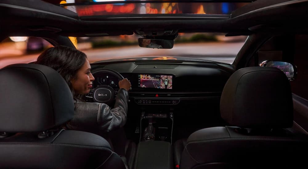 Person driving in a 2025 Kia Sorento at night