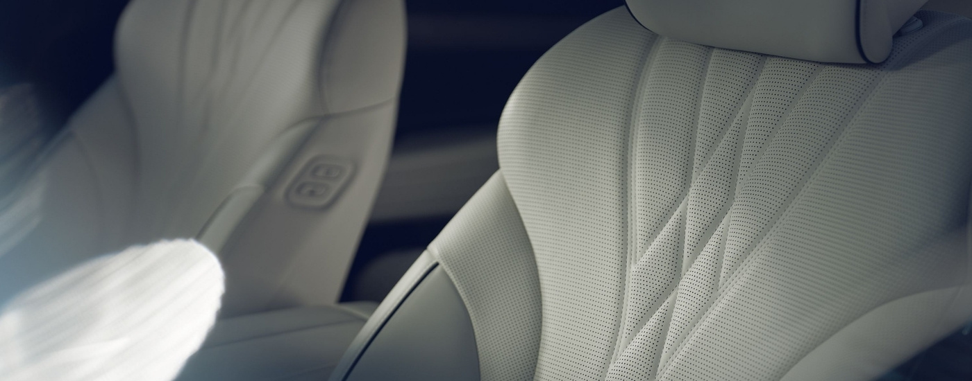 White leather seats in a 2024 Genesis G80 EV at a Genesis dealer near Birmingham
