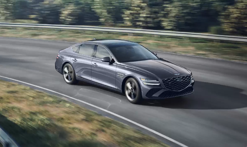 Genesis G80 in Ceres Blue driving on a winding road with motion blur