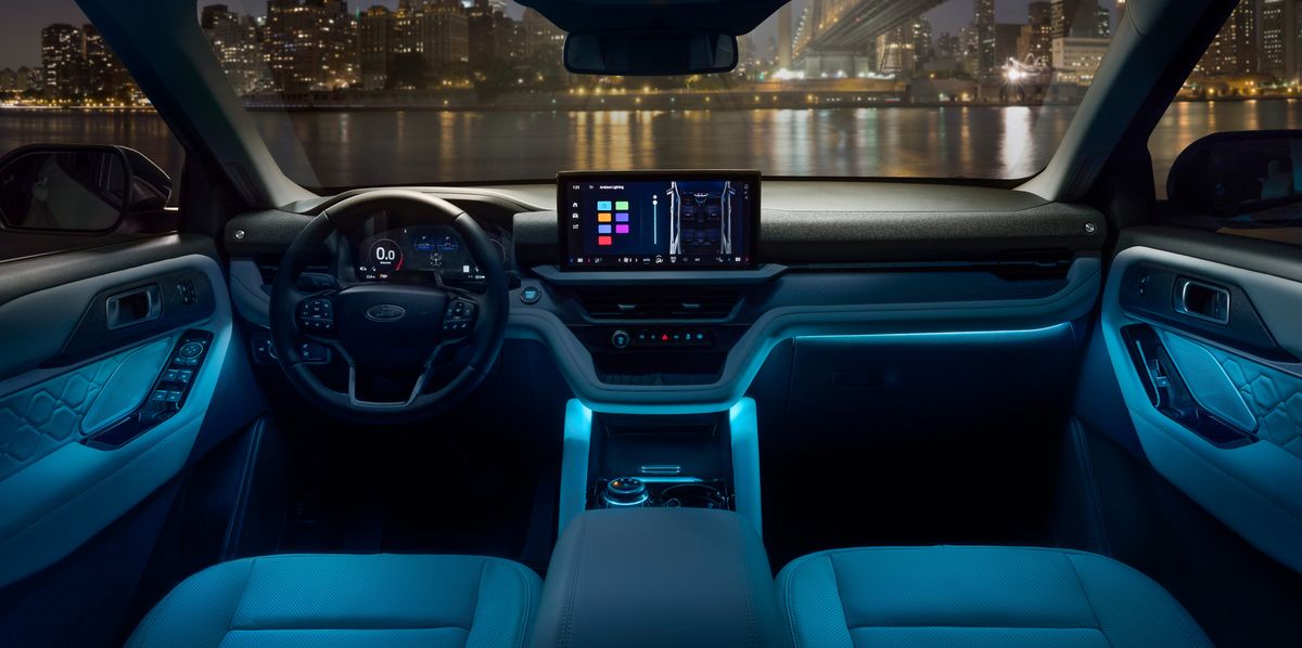 2025 Ford Explorer Platinum model interior lit up while overlooking a night time urban landscape