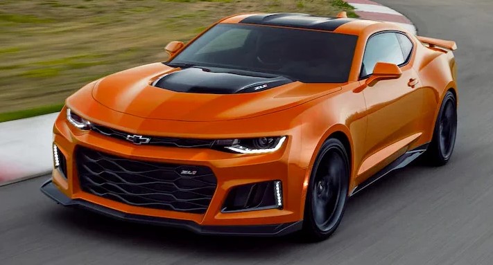 orange camaro driving on a race track