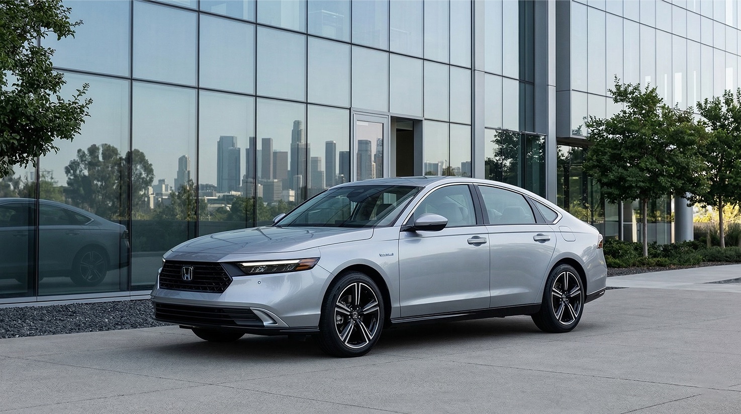 Honda Accord Hybrid sedan parked outside a modern office building representing a fuel efficient commuter vehicle