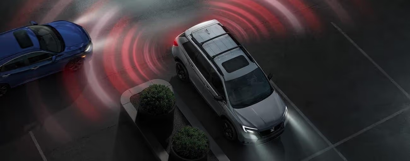 Silver 2020 Honda Passport Elite from above backing out of a parking spot