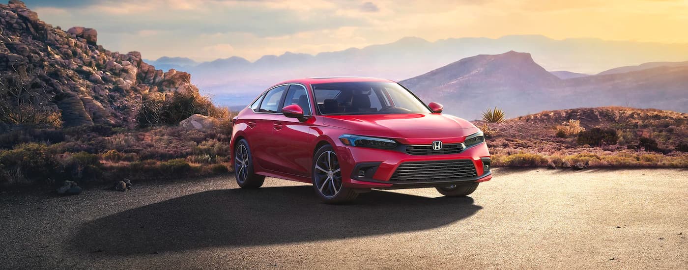 Red 2023 Honda Civic Touring overlooking a mountain