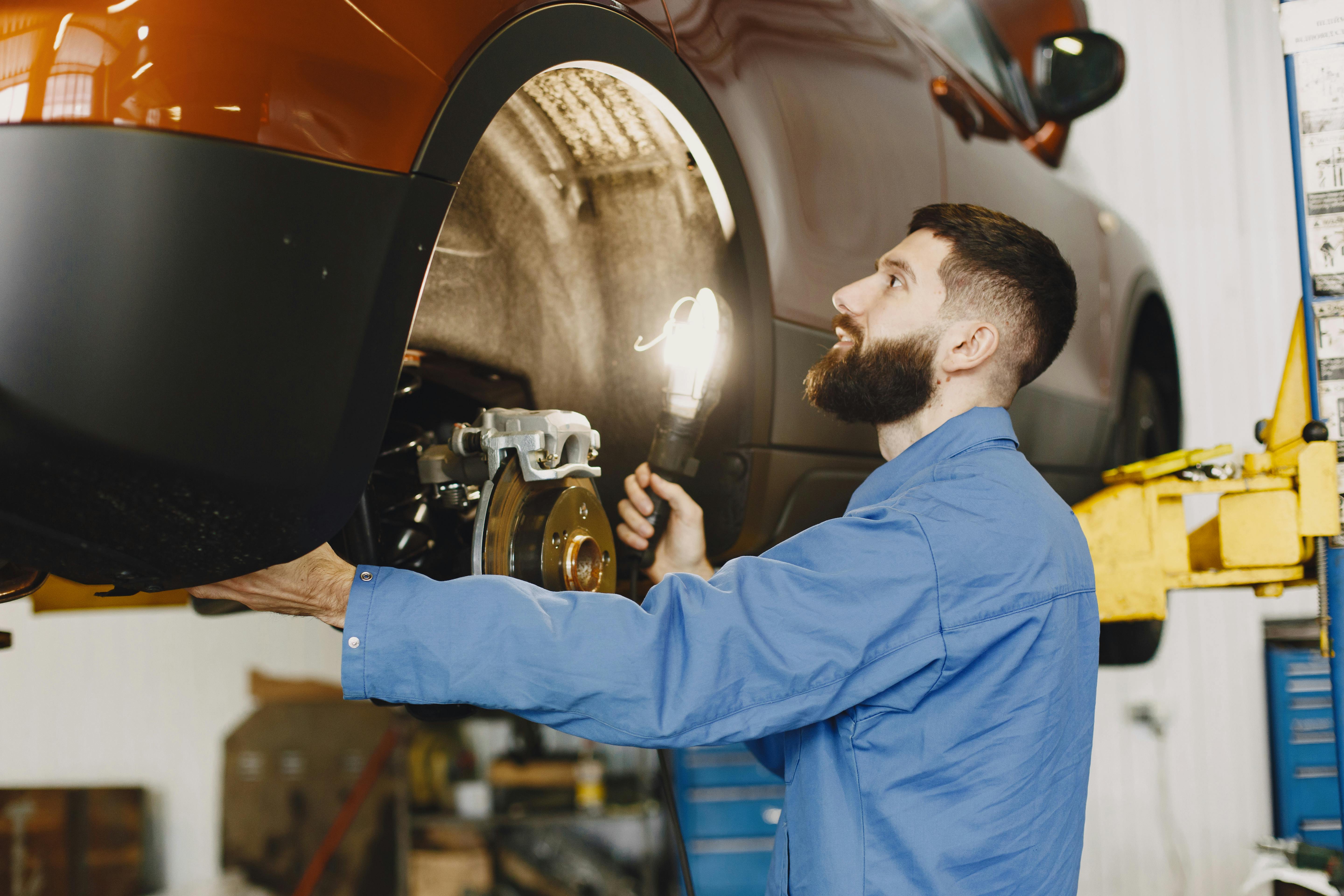 Mechanic servicing vehicle brakes