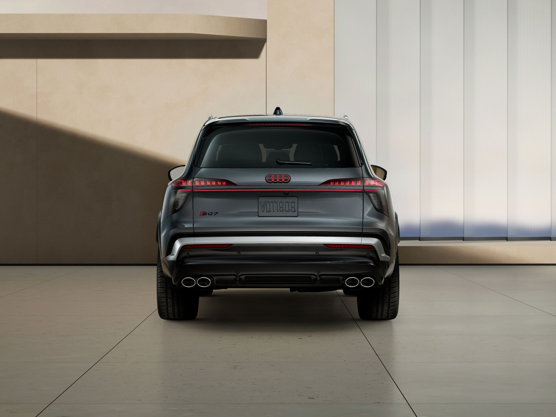2027 Audi SQ7 in gray, rear view with OLED taillights and quad exhaust tips