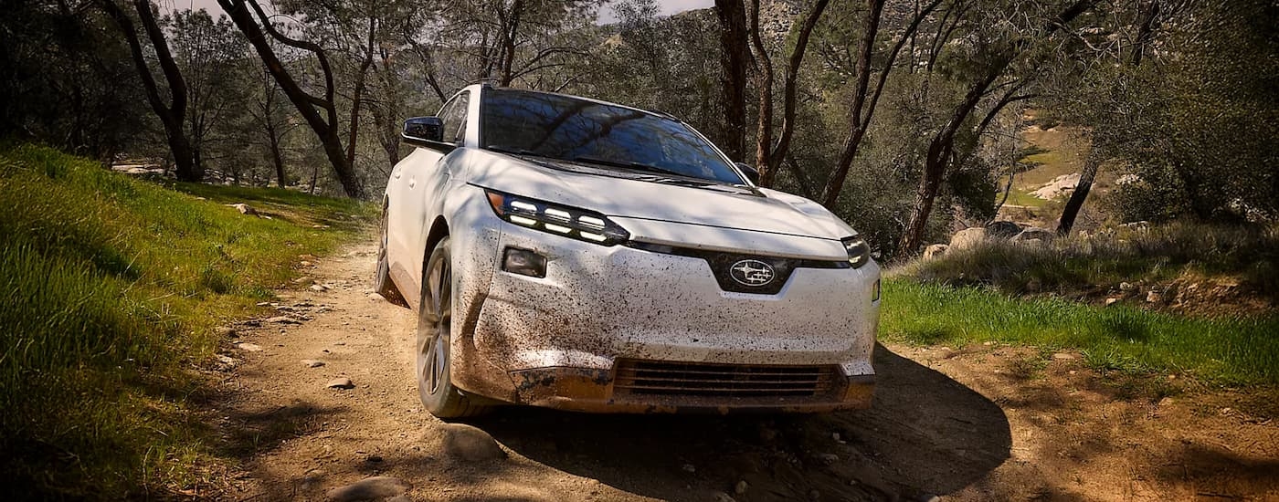 White 2026 Subaru Solterra off-roading on a muddy trail
