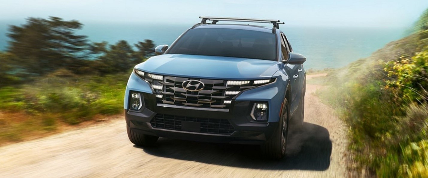 The 2022 Hyundai Santa Cruz driving on a dirt road.