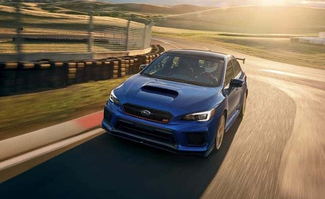 Blue Subaru WRX STI driving on a track