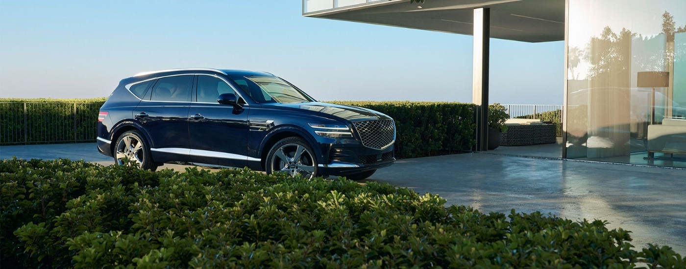 Dark blue 2025 Genesis GV80 parked on a driveway