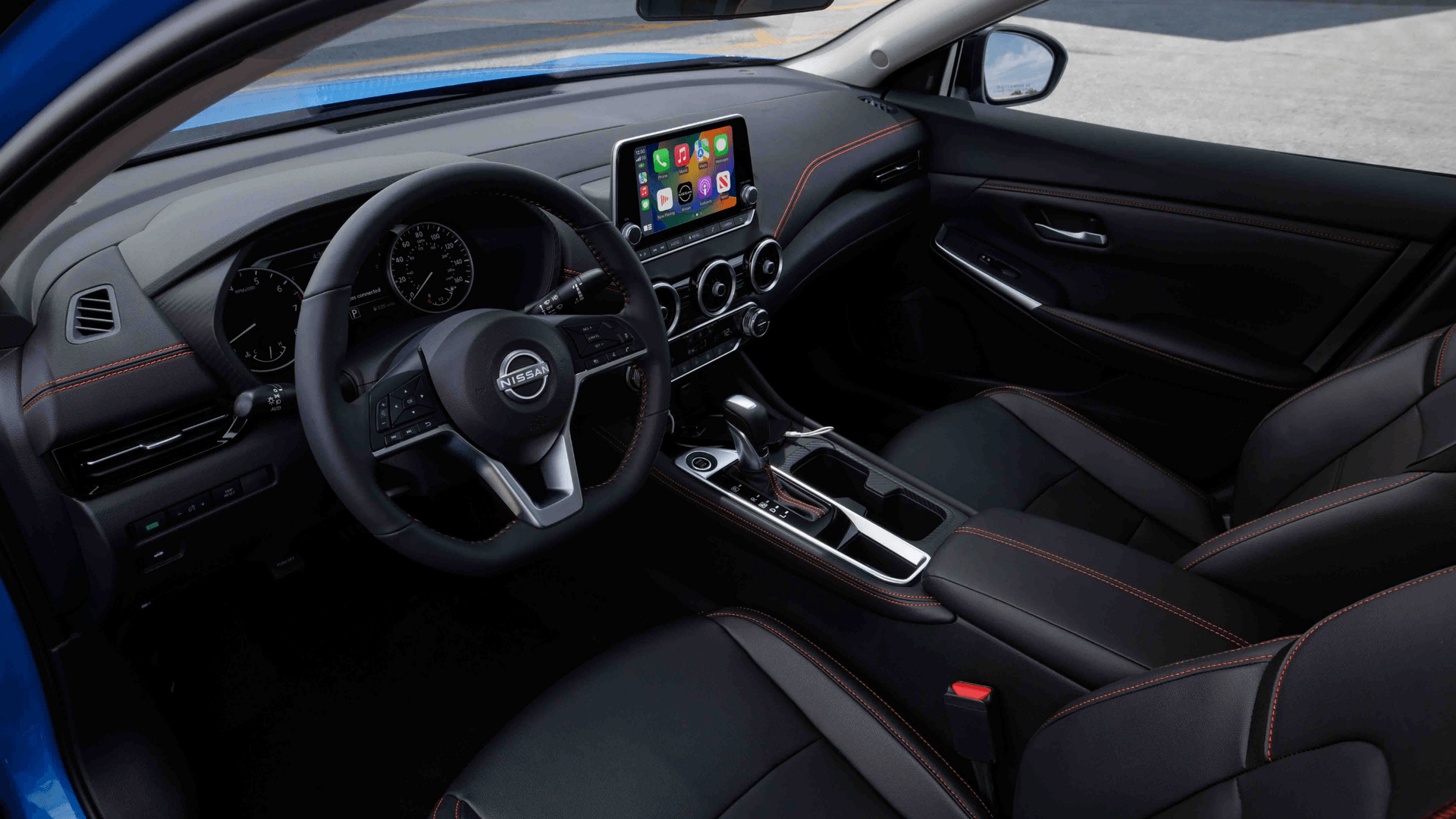 2025 Nissan Sentra® interior showing front seats, steering wheel, center console, and infotainment screen.