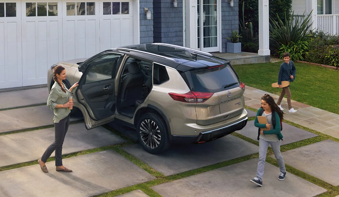 Family preparing to get into a Nissan Rogue
