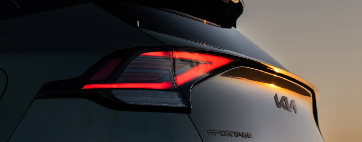 Brakelight on a black 2025 Kia Sportage during a sunset