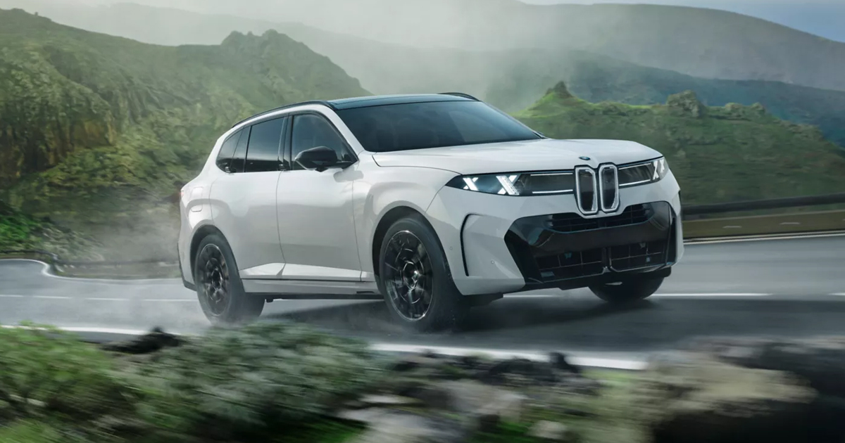 A white BMW X5 driving on mountain roads.