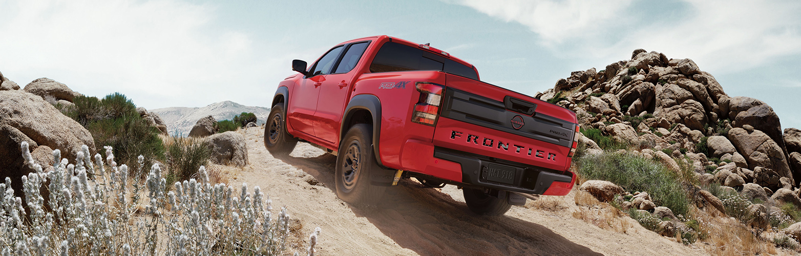 A Nissan Frontier truck parked outdoors, showcasing its rugged design and versatility.
