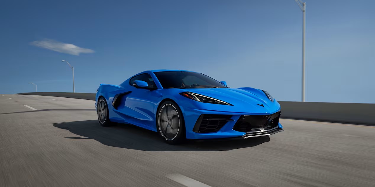 a blue performance car driving on the highway