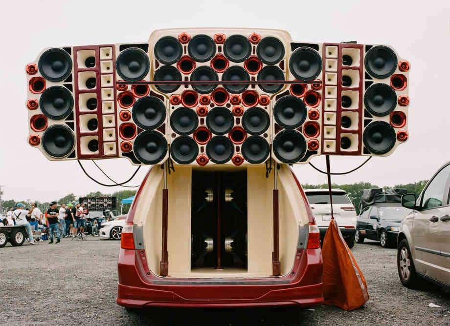 Minivan cargo area filled with a custom wall of speakers