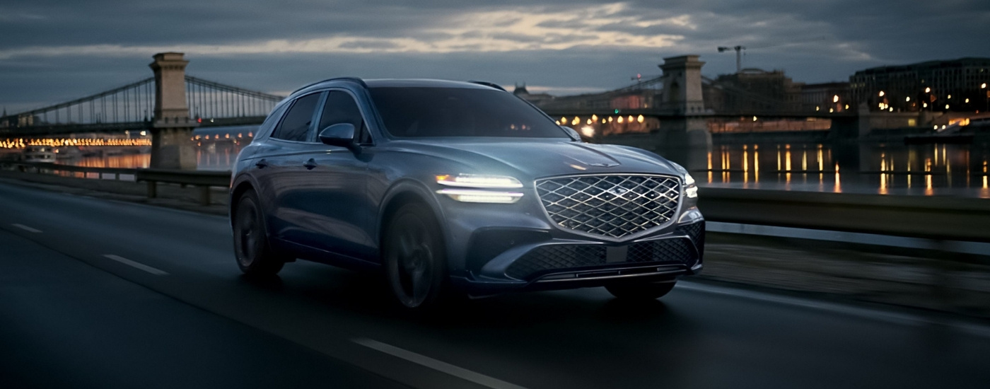 Silver 2026 Genesis GV70 driving on a bridge