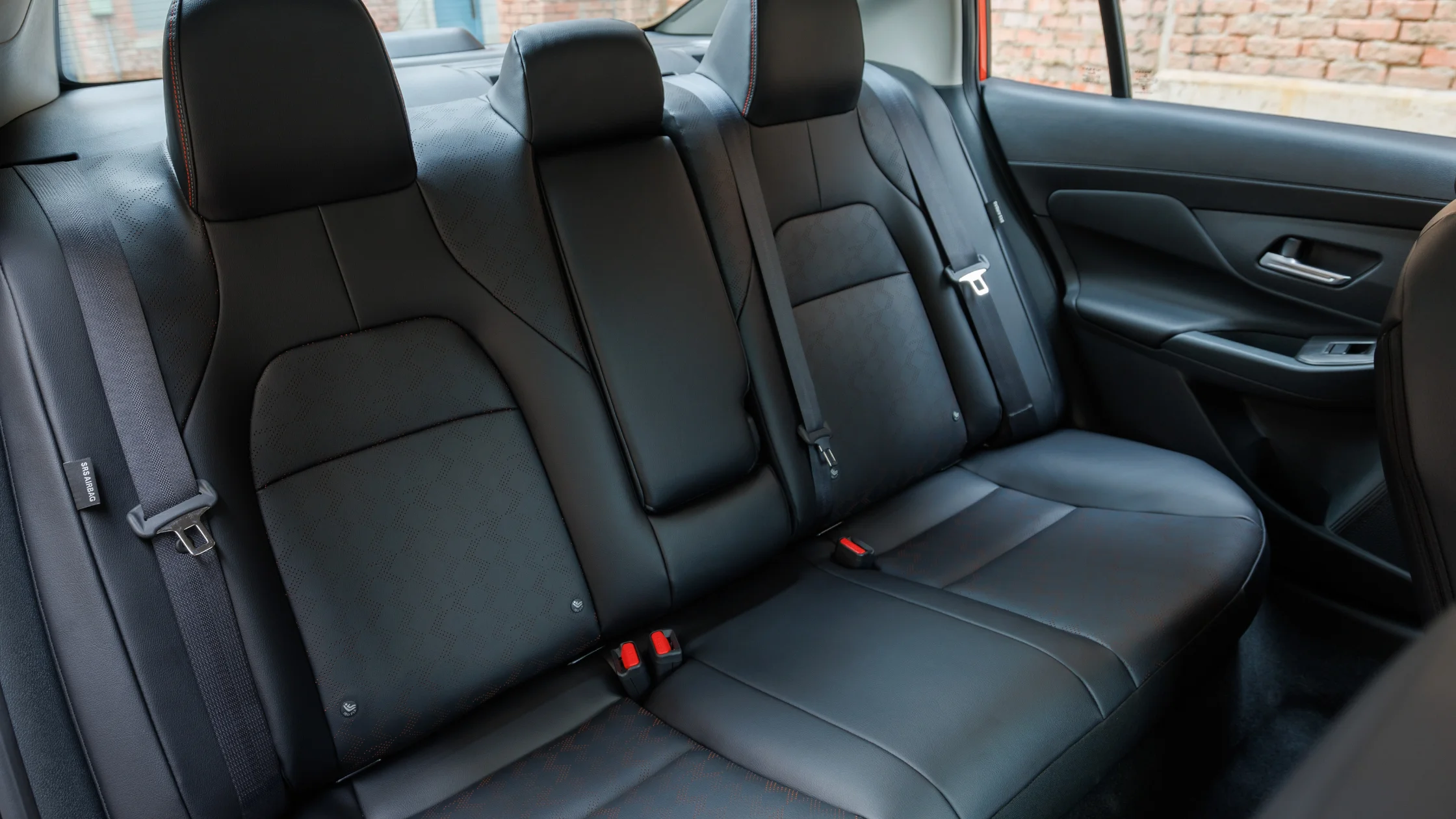 2025 Nissan Sentra® rear seats with black upholstery, headrests, and seatbelt details