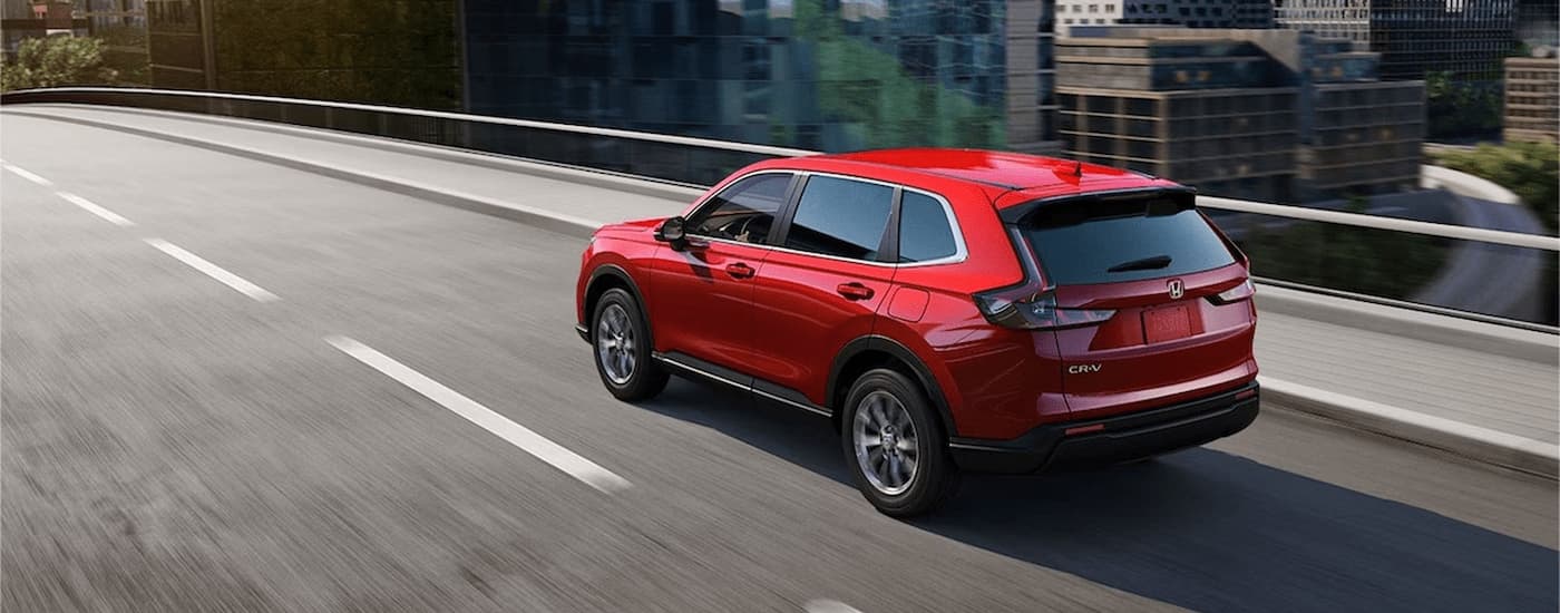 Red 2026 Honda CR-V driving on a highway