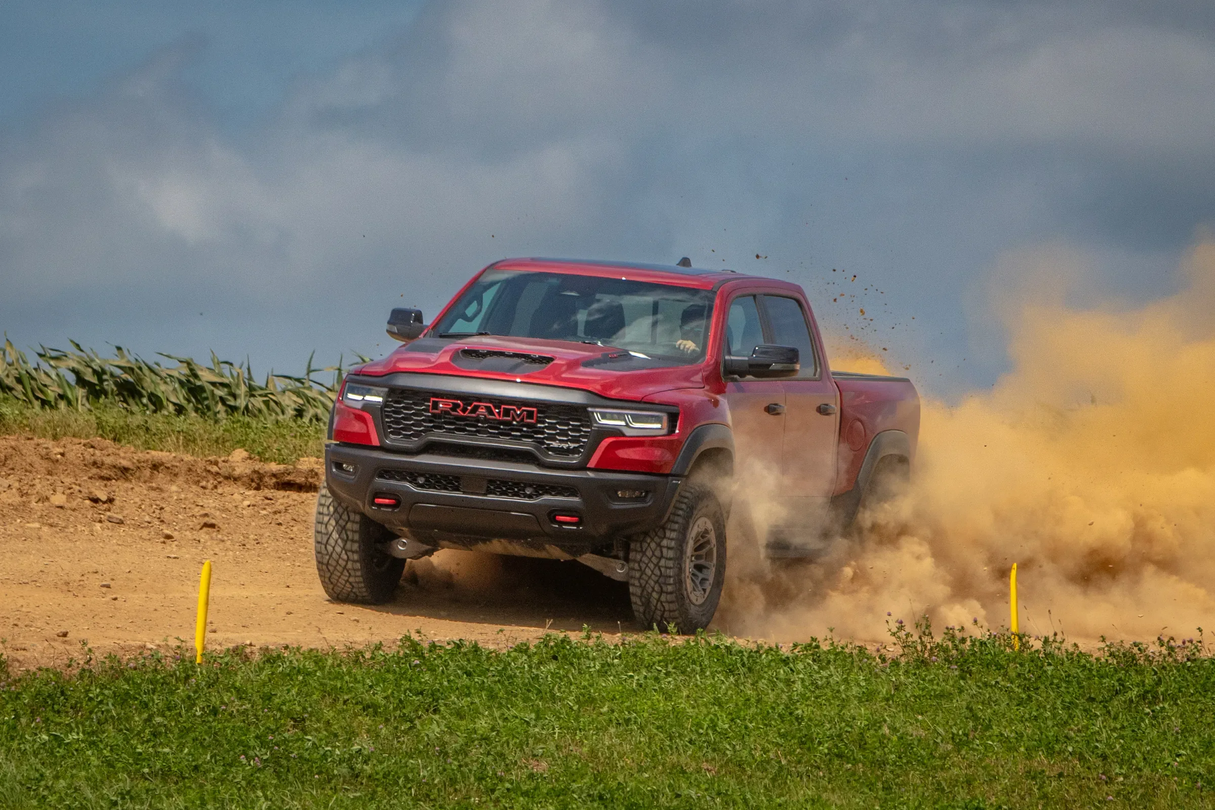 Red Ram performance truck kicking up dirt while driving on an off-road course
