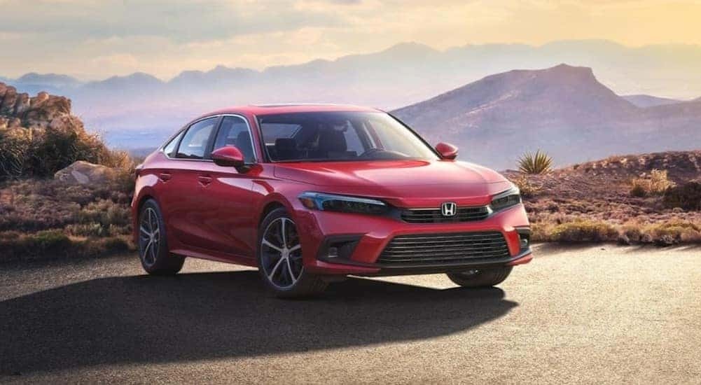 Red 2023 Honda Civic Sport Touring overlooking a mountain view