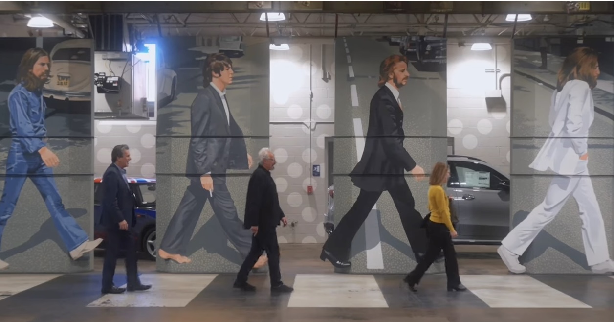 John Masano walking near Abbey Road mural at Masano Auto Park in Reading, PA