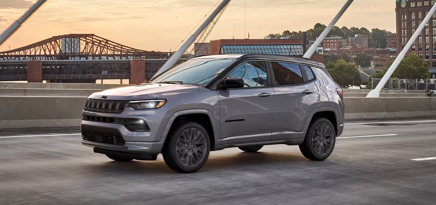 A gray 2022 Jeep Compass driving on the road.