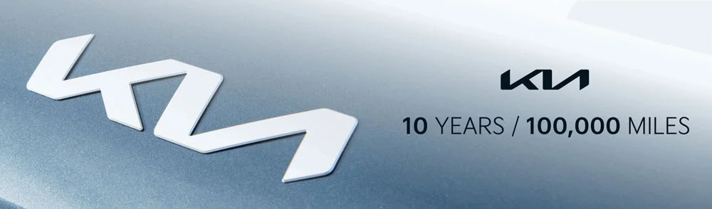 Kia emblem on a vehicle hood alongside the Kia logo and "10 YEARS / 100,000 MILES" warranty text.