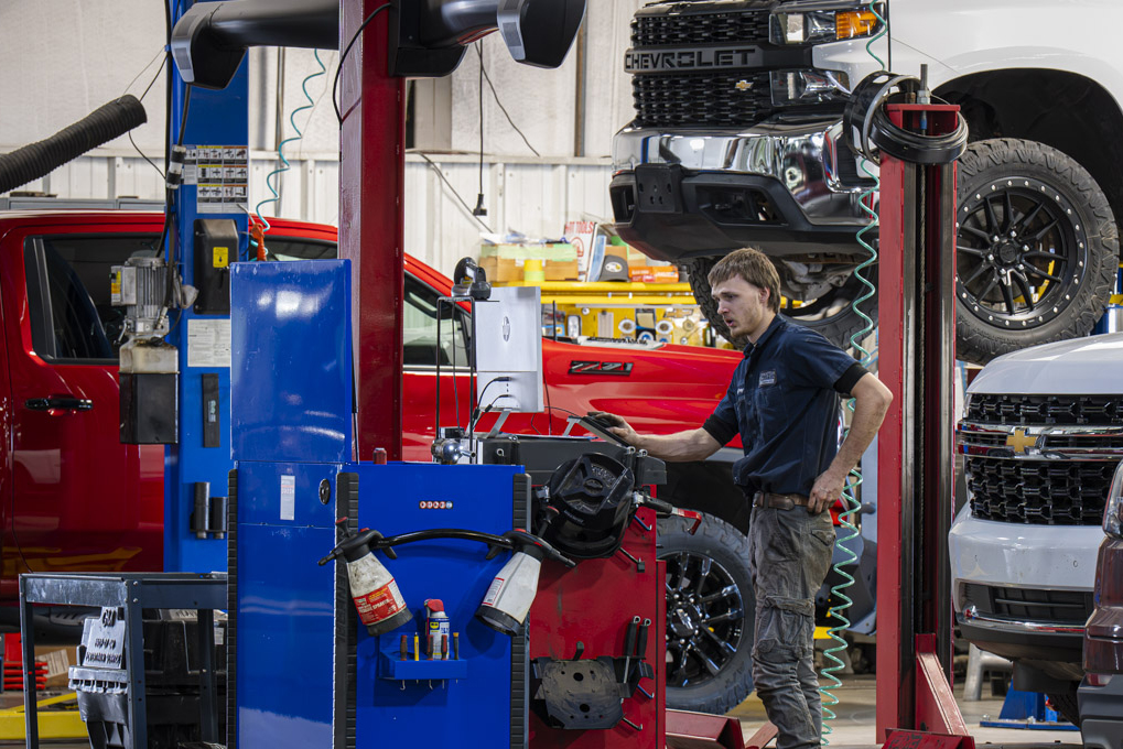 Automotive technician at Don Hattan Chevrolet performing an alignment on a Chevrolet truck.