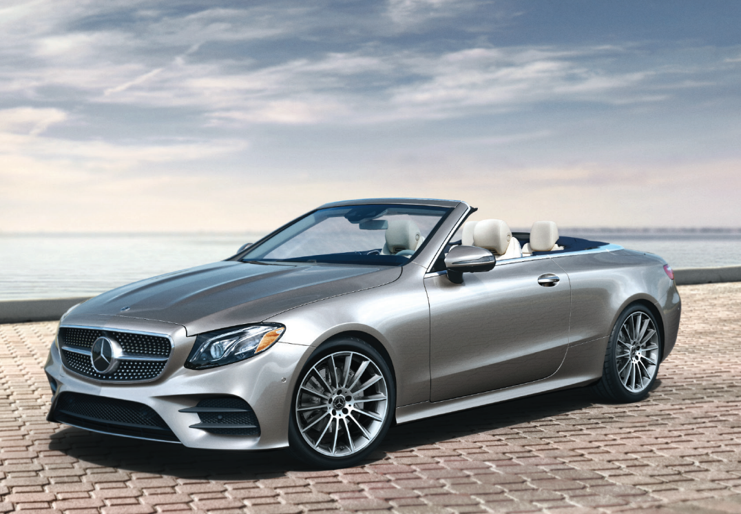 Certified technician applying DuPont paint protection film to a Mercedes-Benz
