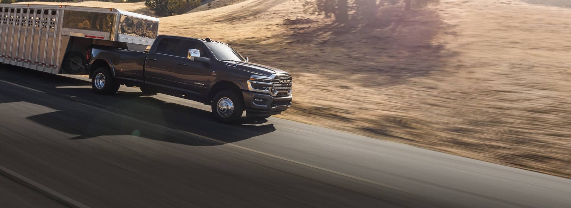 2026 RAM 3500 Limited Longhorn dually towing a livestock trailer; manufacturer image