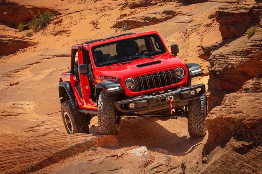 2026 Jeep Wrangler Exterior with WARN Winch Passenger Side Front Angle while Rock Crawling