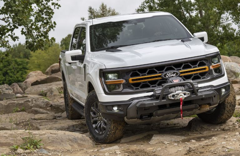 White 2024 Ford F-150 Tremor on a Rocky Trail with Winch