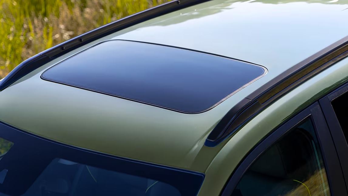 photo looking down at a sunroof on a cacti green 2024 Chevy Trax