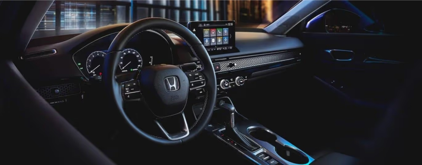 Black interior and dash are shown in a 2022 Honda Civic Touring