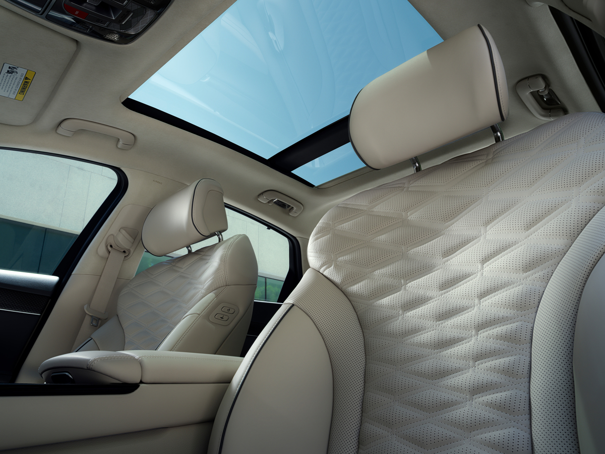 Interior view of sunroof and front seats from driver seat pov inside the Genesis G80