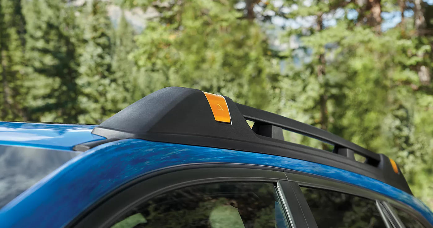 Blue Subaru roof rails with copper-finish accents