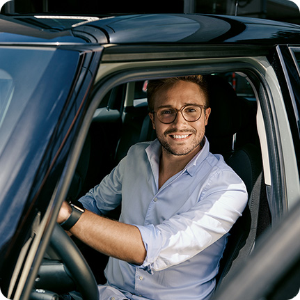 A customer sitting in the driver’s seat of a MINI with the door   open. 