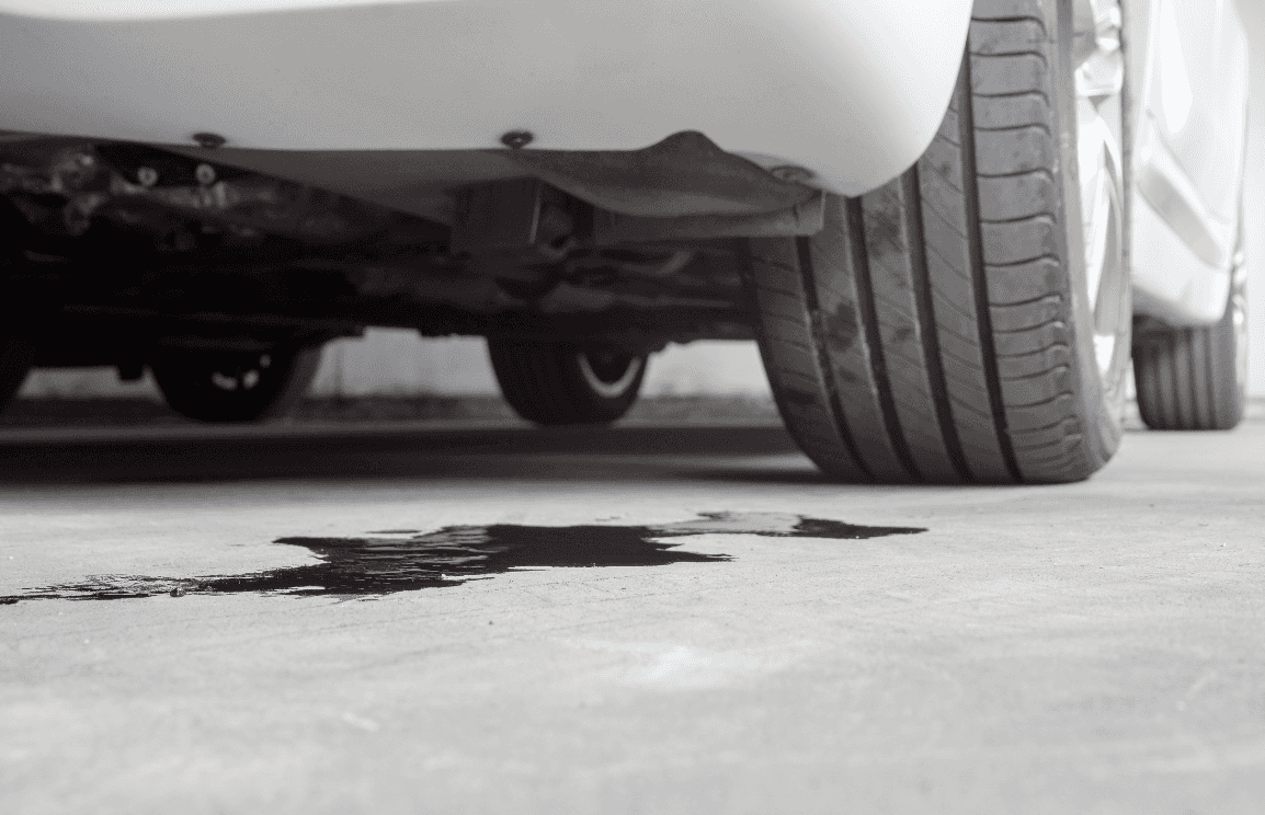 A vehicle leaking engine oil on the ground